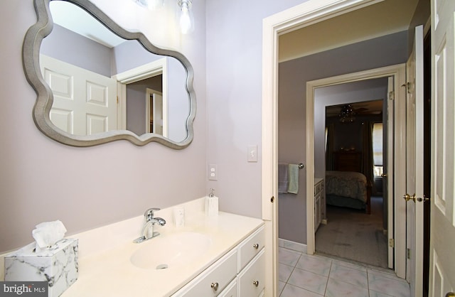 bathroom with tile patterned flooring, vanity, and ceiling fan