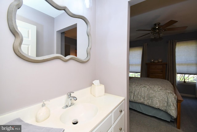 ensuite bathroom featuring vanity, a ceiling fan, and connected bathroom