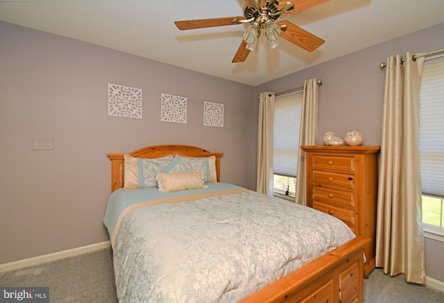 bedroom with baseboards, ceiling fan, and light carpet