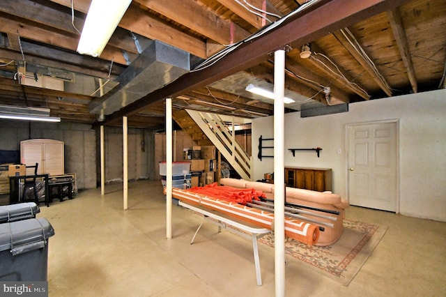 unfinished below grade area featuring stairs