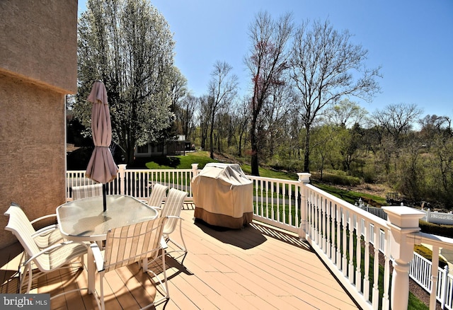 wooden terrace with outdoor dining space