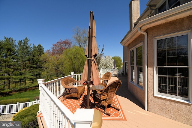 wooden terrace with fence and outdoor dining area