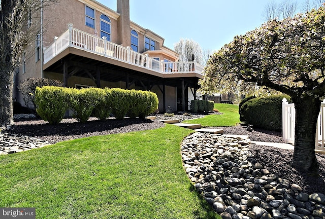 back of property featuring a yard and stucco siding