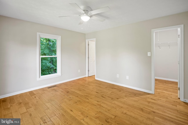 804 Farms River Rd, Front Royal, VA 22630 - unfurnished bedroom with light wood finished floors, a spacious closet, baseboards, and a closet