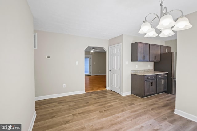 804 Farms River Rd, Front Royal, VA 22630 - kitchen with freestanding refrigerator, a chandelier, dark brown cabinetry, and light wood-style flooring