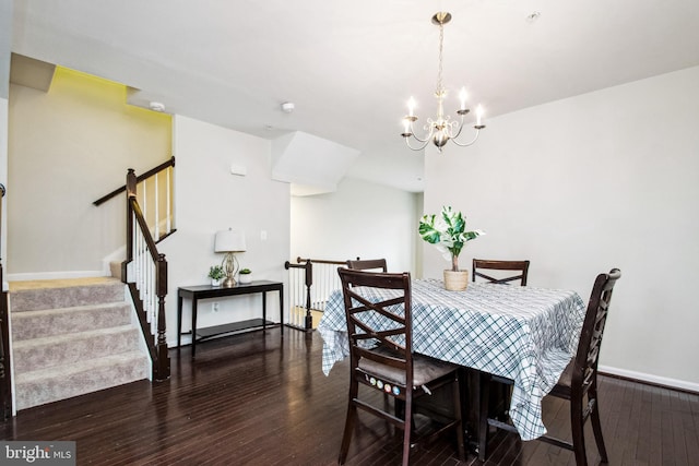 dining room featuring baseboards, stairway, a notable chandelier, and wood finished floors