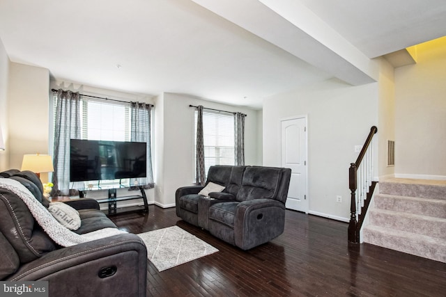 living room with visible vents, stairs, baseboards, and hardwood / wood-style flooring