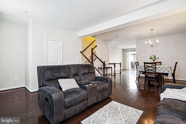 living area with stairway, dark wood-type flooring, baseboards, and an inviting chandelier