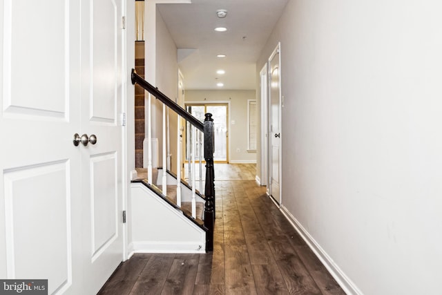 hallway with recessed lighting, baseboards, dark wood-style floors, and stairs