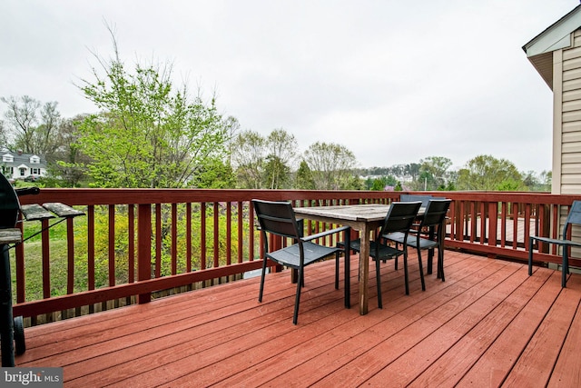wooden deck featuring outdoor dining area