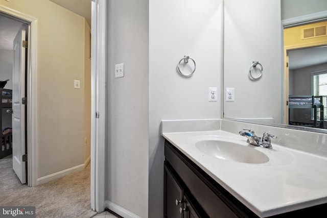 bathroom featuring vanity, visible vents, and baseboards