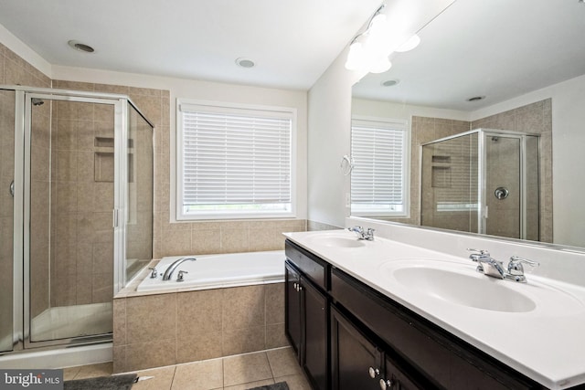 bathroom with a shower stall, a garden tub, and a sink