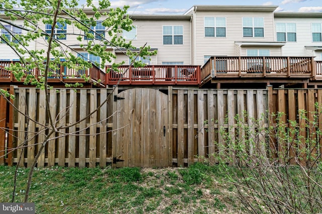 back of house featuring fence and a deck
