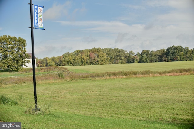 view of landscape with a rural view and a view of trees