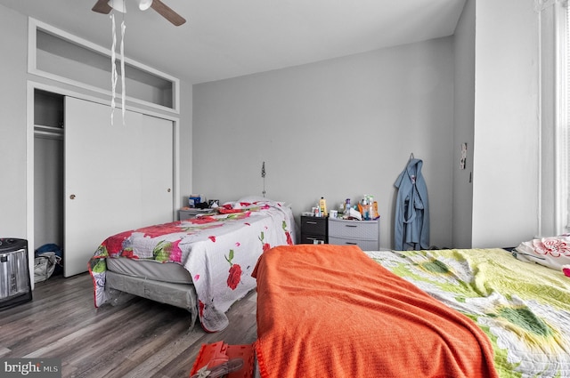 bedroom with a closet, wood finished floors, and ceiling fan