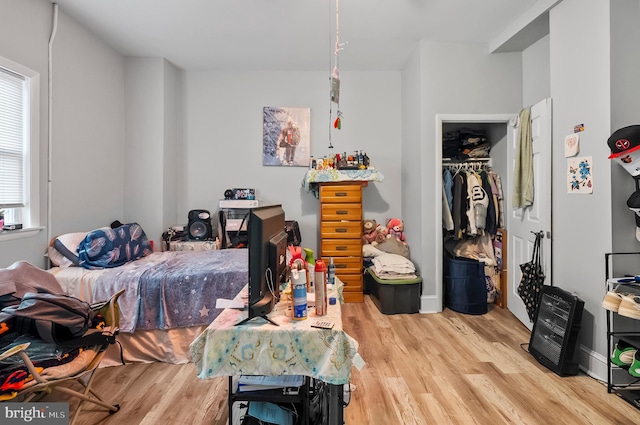 bedroom featuring wood finished floors and a closet