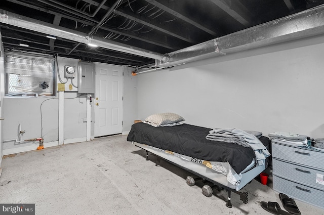 bedroom with concrete flooring and electric panel