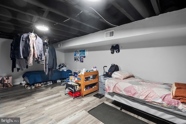 bedroom featuring visible vents and wood finished floors