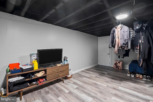 finished basement featuring baseboards and wood finished floors