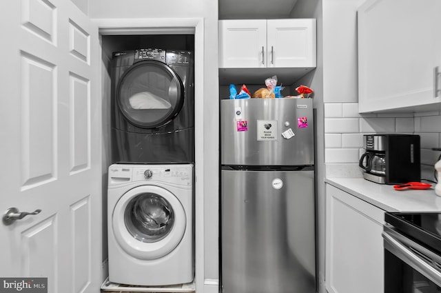 laundry room featuring stacked washing maching and dryer and laundry area