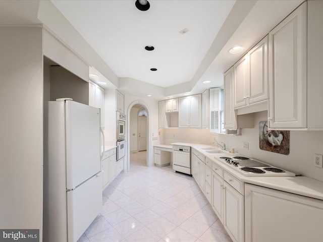 1324 Ramseur Ln, Winchester, VA 22601 - kitchen with a sink, white appliances, arched walkways, light countertops, and recessed lighting