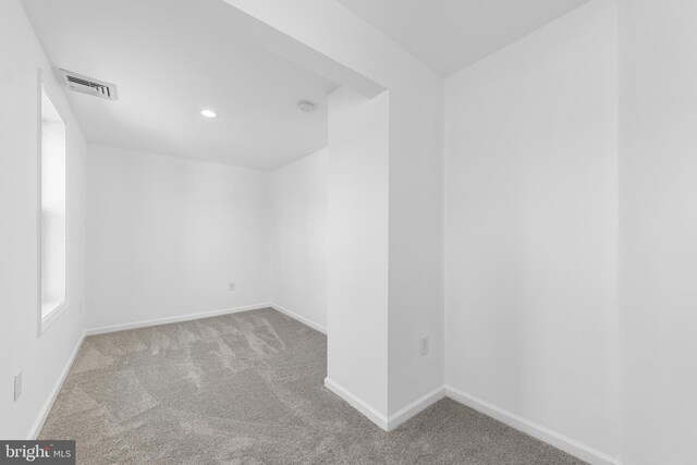 empty room with recessed lighting, visible vents, carpet floors, and baseboards