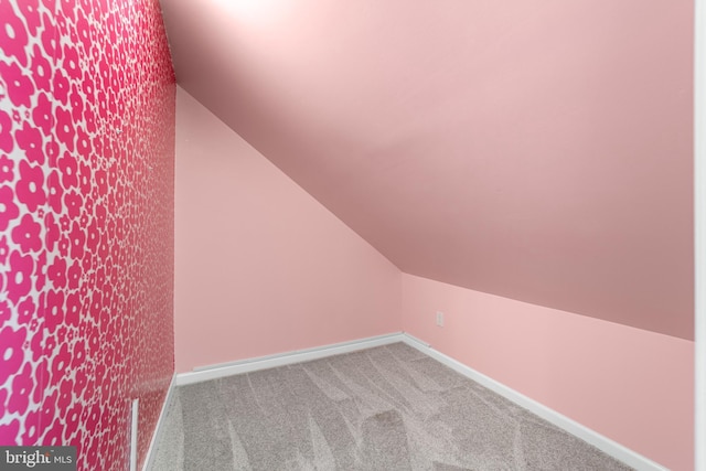 additional living space featuring lofted ceiling, baseboards, and carpet floors