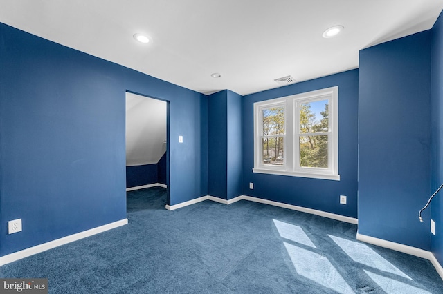 unfurnished room featuring baseboards, visible vents, dark colored carpet, and recessed lighting