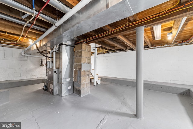 unfinished below grade area featuring heating unit
