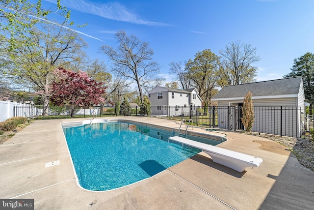 view of pool featuring fence, a diving board, a patio area, and a fenced in pool