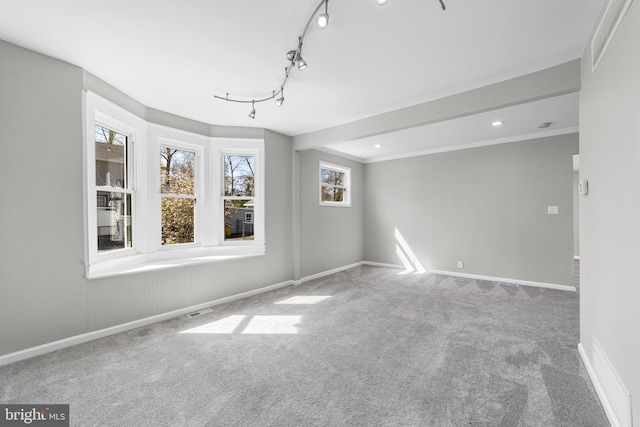 spare room featuring recessed lighting, carpet flooring, crown molding, visible vents, and baseboards