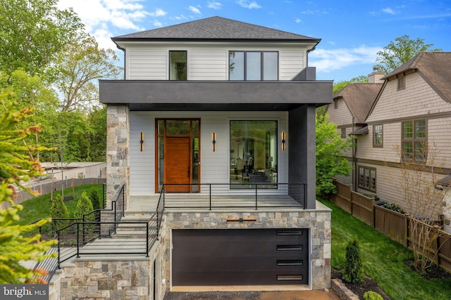 1853 Massachusetts Ave, Mclean, VA 22101 - rear view of house with an attached garage, fence, stone siding, and driveway