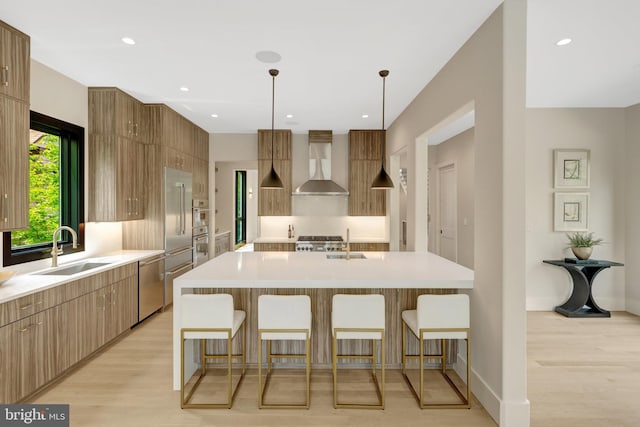 1853 Massachusetts Ave, Mclean, VA 22101 - kitchen featuring wall chimney range hood, a sink, modern cabinets, a kitchen breakfast bar, and recessed lighting
