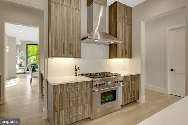 1853 Massachusetts Ave, Mclean, VA 22101 - kitchen featuring high end stove, wall chimney exhaust hood, modern cabinets, and light wood-style flooring
