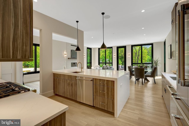 1853 Massachusetts Ave, Mclean, VA 22101 - kitchen with healthy amount of natural light, a sink, light wood-type flooring, pendant lighting, and recessed lighting