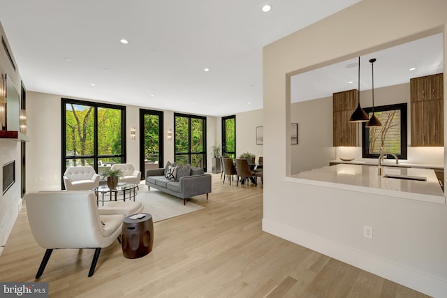 1853 Massachusetts Ave, Mclean, VA 22101 - living area with recessed lighting, light wood finished floors, a glass covered fireplace, and baseboards