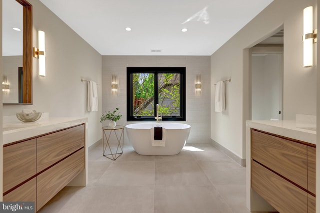 1853 Massachusetts Ave, Mclean, VA 22101 - full bathroom featuring two vanities, a freestanding tub, baseboards, recessed lighting, and tile patterned floors