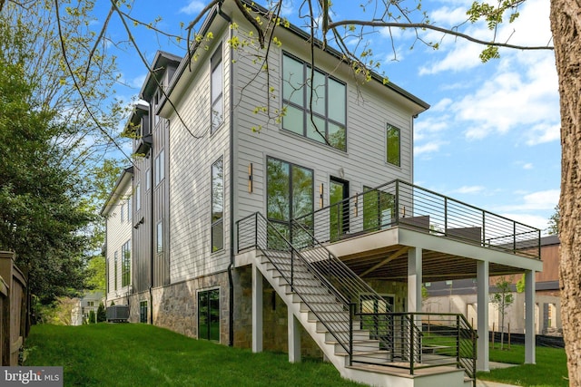 1853 Massachusetts Ave, Mclean, VA 22101 - back of property featuring central AC unit, a wooden deck, a lawn, stairs, and stone siding
