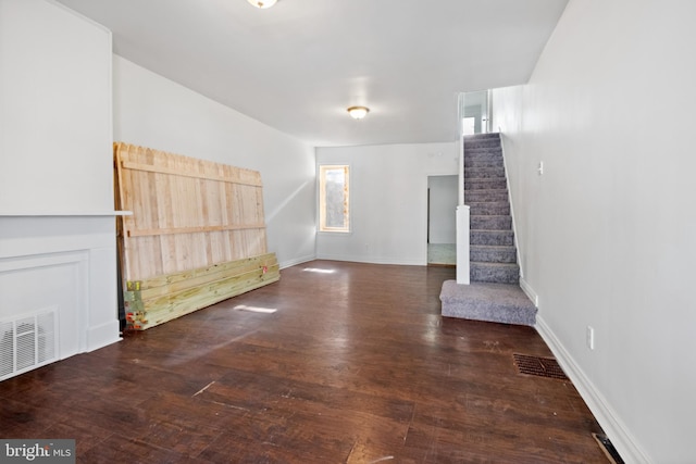 interior space featuring stairway, visible vents, and wood finished floors