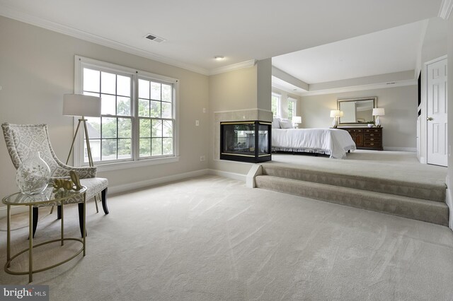 bedroom with crown molding, carpet, baseboards, and multiple windows