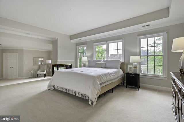 bedroom with light carpet, crown molding, and baseboards