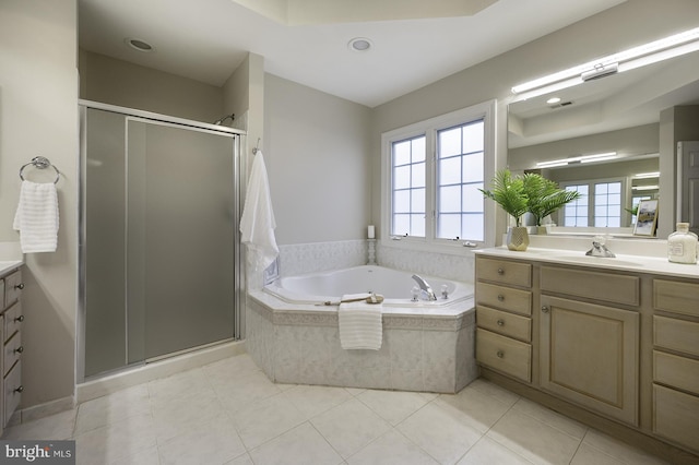 bathroom featuring vanity, plenty of natural light, a garden tub, and a stall shower
