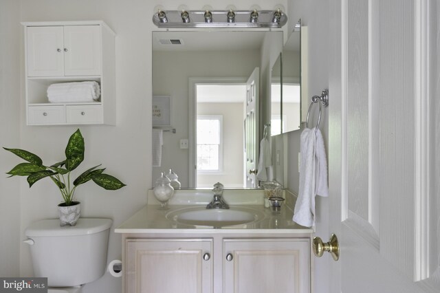 bathroom with toilet and vanity