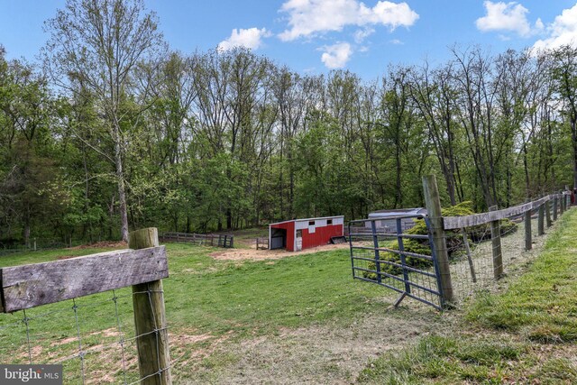 212 Mowry Ln, Edinburg, VA 22824 - view of yard with an outbuilding, a view of trees, a pole building, fence, and a rural view