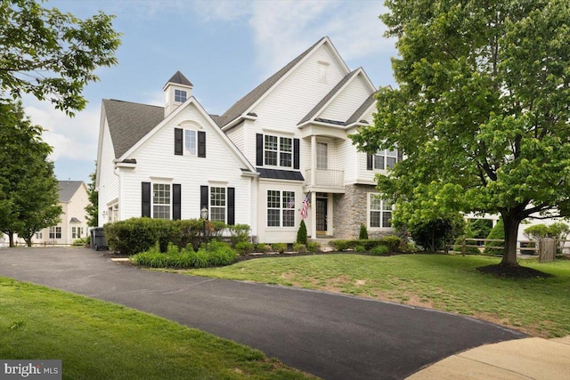 7135 Hills Ln, Warrenton, VA 20187 - view of front of home with stone siding, a front yard, and a shingled roof