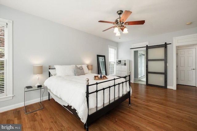 7135 Hills Ln, Warrenton, VA 20187 - bedroom featuring a barn door, baseboards, wood finished floors, and ceiling fan