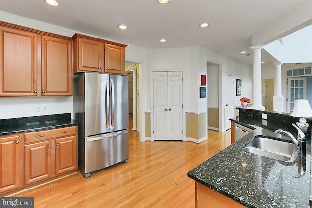 kitchen featuring a sink, light wood-style floors, freestanding refrigerator, recessed lighting, and ornate columns