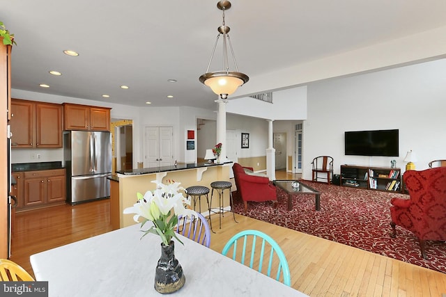 dining space featuring visible vents, ornate columns, wood-type flooring, and recessed lighting