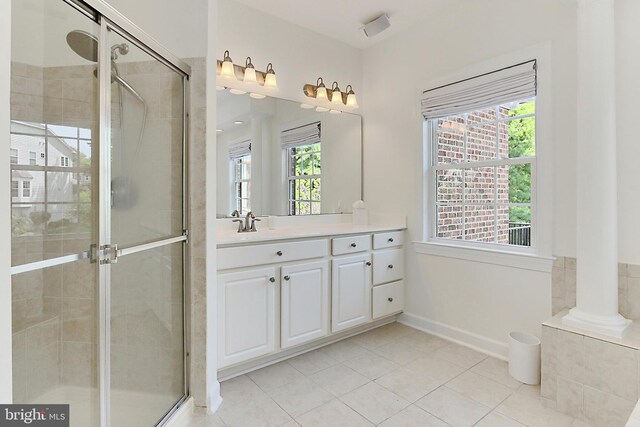 full bath with tile patterned flooring, a shower stall, vanity, and a healthy amount of sunlight