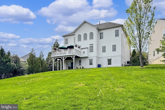 back of house featuring a deck and a yard